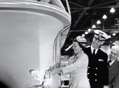 Old Photo of People Touching a Boat in Black and White
